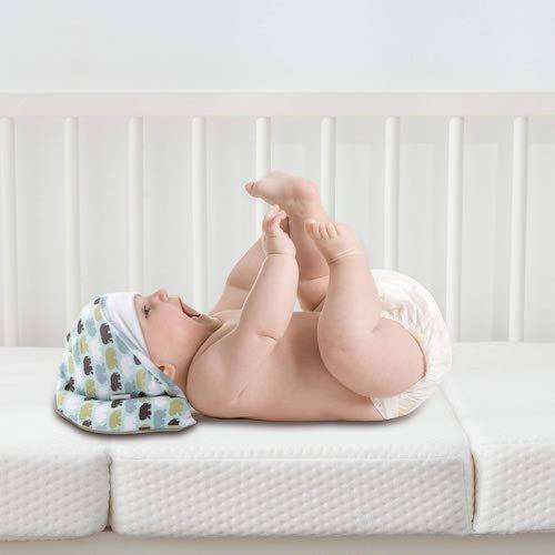 Baby lying on pack n play mattress